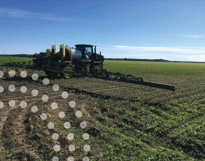 Machine applying side-dress UAN to cornfield.